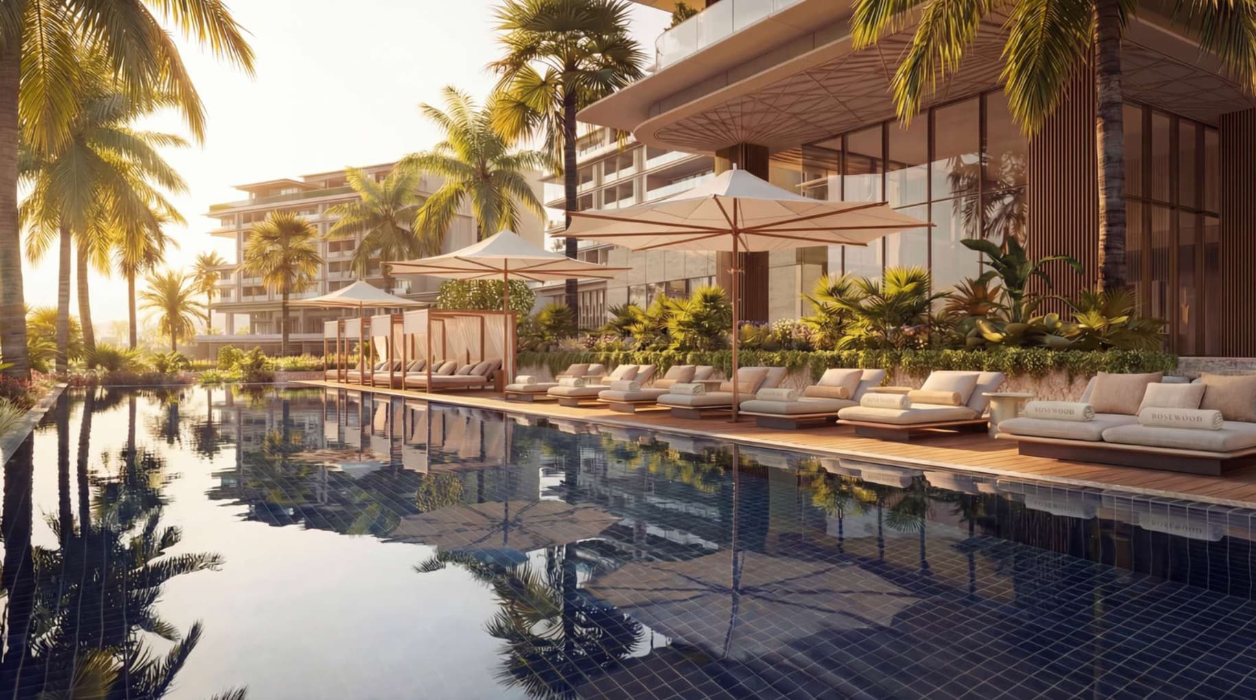 The Rosewood residential pool lined with palms and waterfront terraces